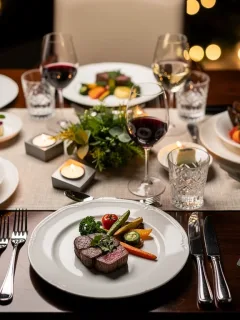 Gourmet meal on a dining table with a credit card, symbolizing rewards.