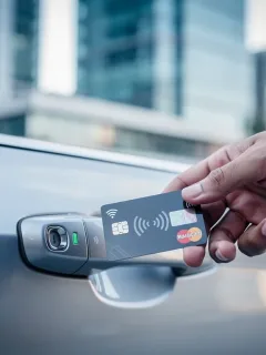Credit card unlocking a rental car, symbolizing insurance benefits