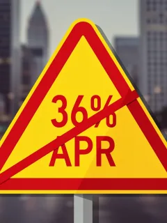 Warning sign for high APR loans in the US amid city backdrop