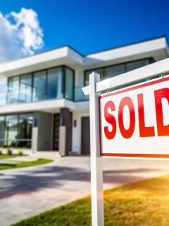 Sold sign in front of a modern house, symbolizing quick real estate liquidity in 2026.