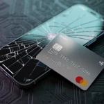 Cracked smartphone screen protected by a credit card, symbolizing cell phone insurance