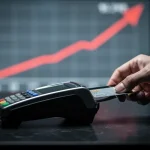 Credit card being used at a terminal, representing increasing US household debt