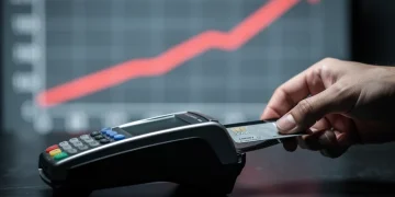 Credit card being used at a terminal, representing increasing US household debt