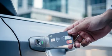 Credit card unlocking a rental car, symbolizing insurance benefits